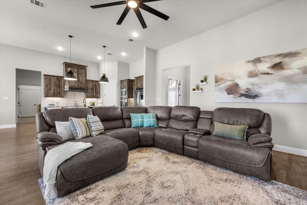 329 Palo Alto Drive Springtown, TX 76082 - Photo 7 of 34 Open-concept living area featuring light-toned walls, wood-finish flooring, recessed lighting, and a ceiling fan
