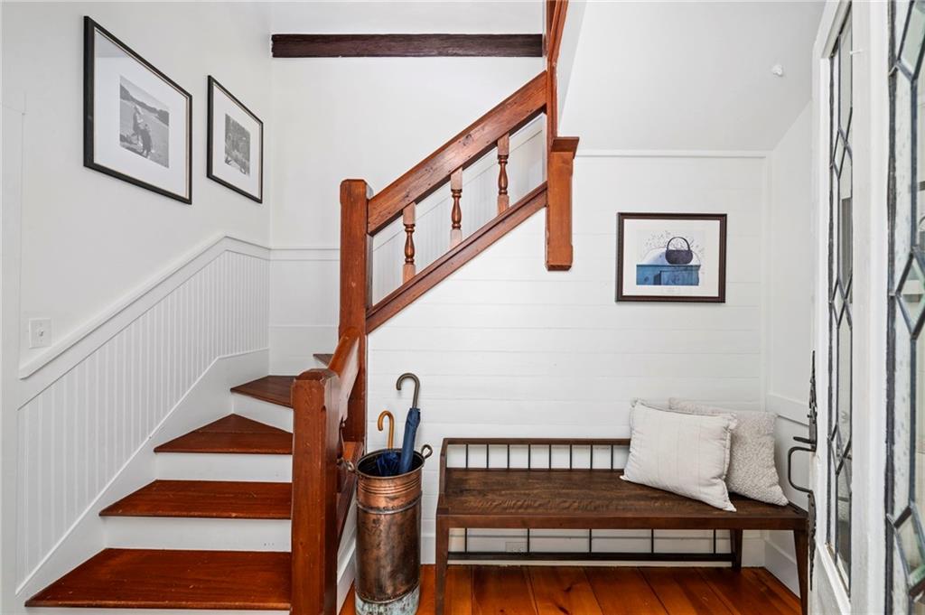 1550 Lackey Road Roswell, GA 30075 - Photo 13 of 92 a view of staircase with lots of frames on wall and a window