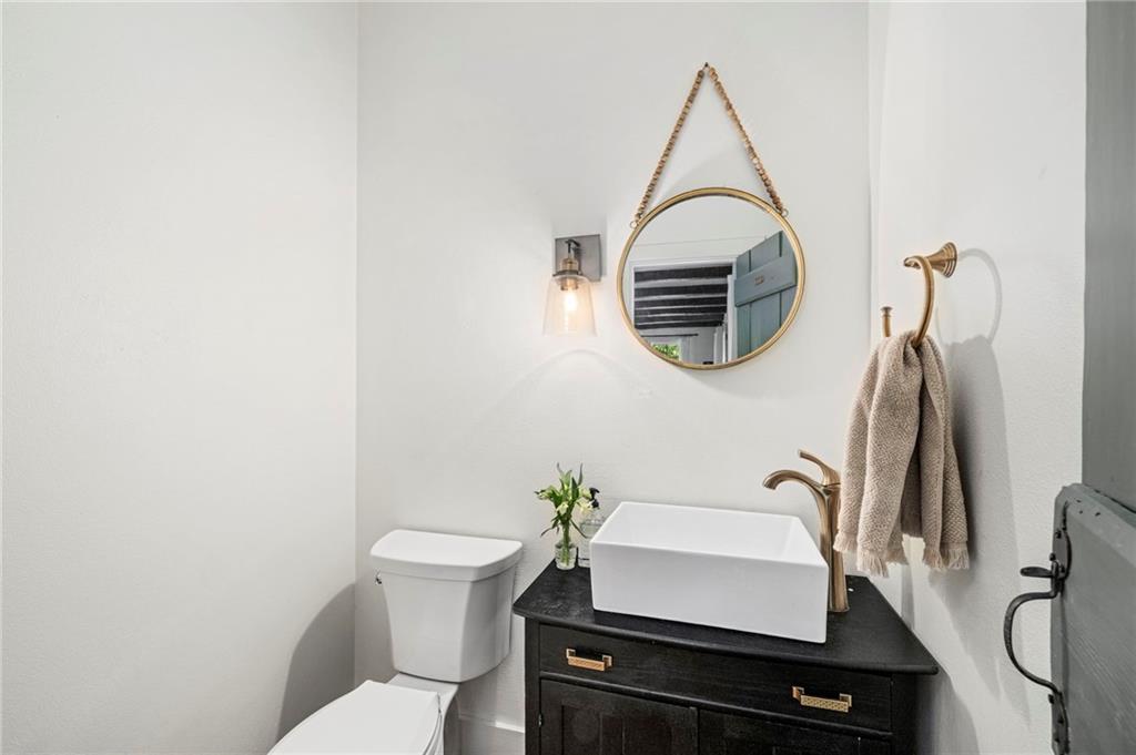 1550 Lackey Road Roswell, GA 30075 - Photo 40 of 92 a bathroom with a sink a toilet and a mirror