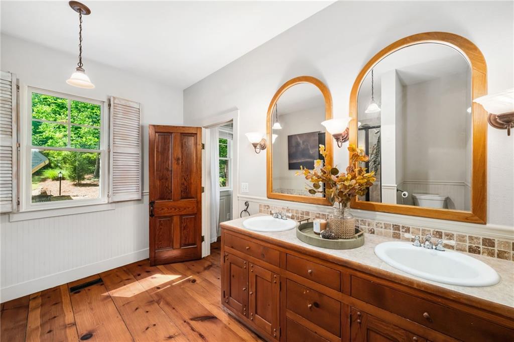 1550 Lackey Road Roswell, GA 30075 - Photo 42 of 92 a spacious bathroom with a granite countertop sink mirror and shower