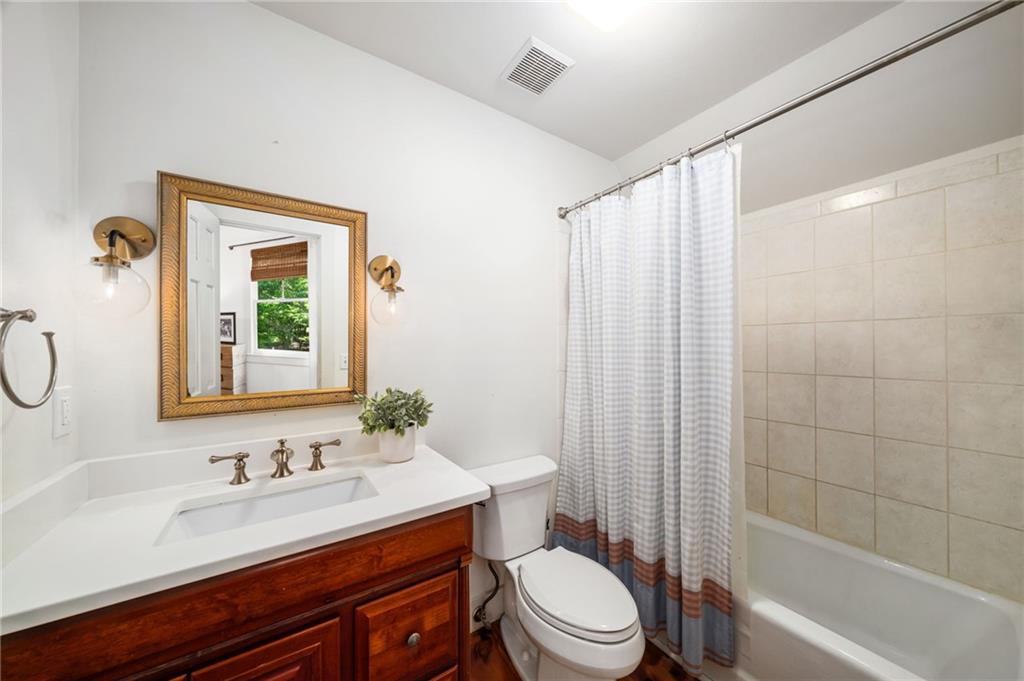 1550 Lackey Road Roswell, GA 30075 - Photo 48 of 92 a bathroom with a granite countertop sink toilet a mirror and shower
