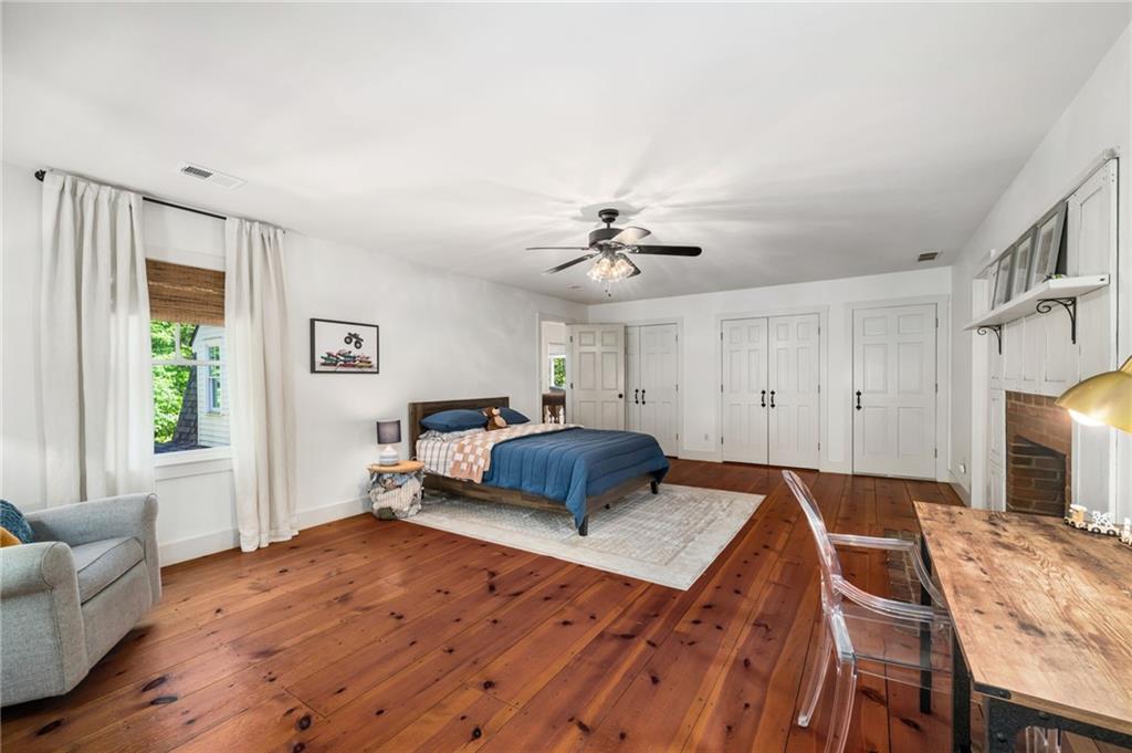 1550 Lackey Road Roswell, GA 30075 - Photo 52 of 92 a bedroom with a bed and wooden floor