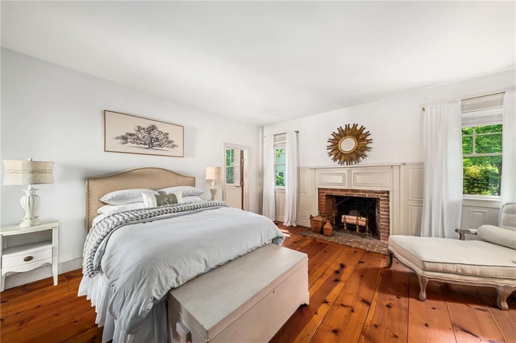 1550 Lackey Road Roswell, GA 30075 - Photo 7 of 92 a spacious bedroom with a bed and a fireplace