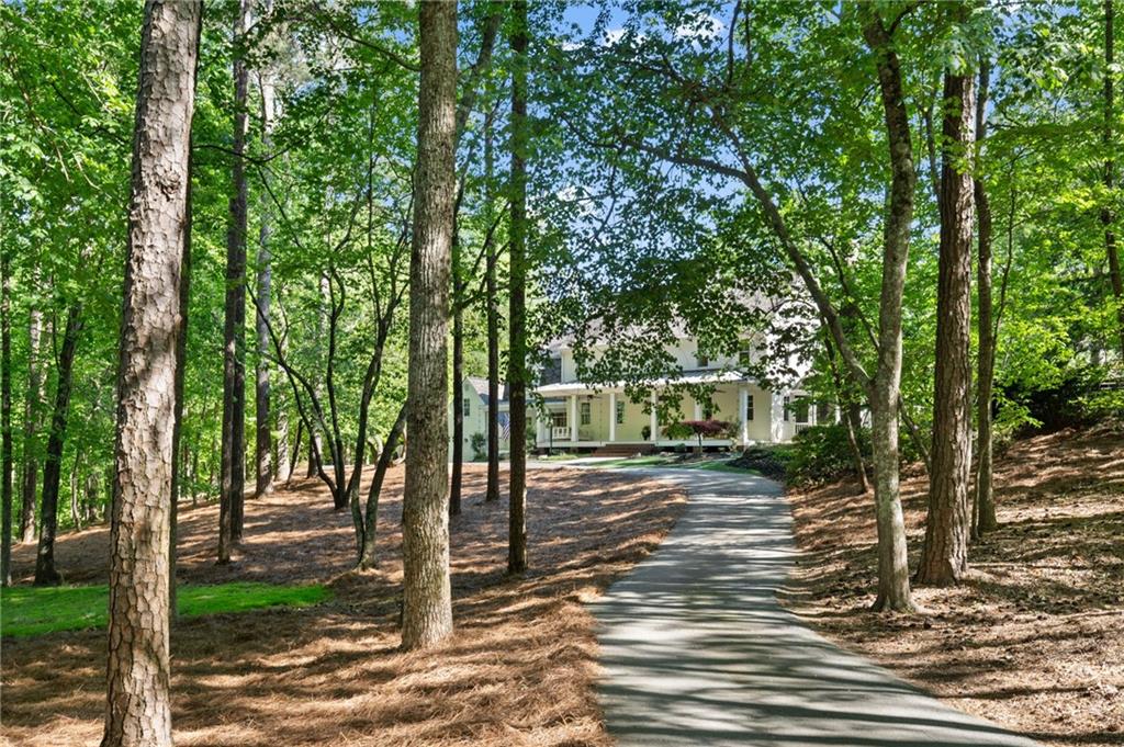 1550 Lackey Road Roswell, GA 30075 - Photo 90 of 92 a front view of a house with a tree