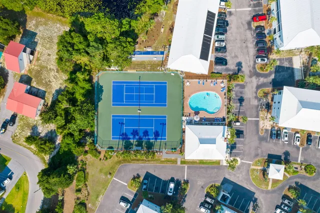 an aerial view of a house with a yard and patio