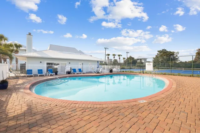 a view of a swimming pool with a table and chairs