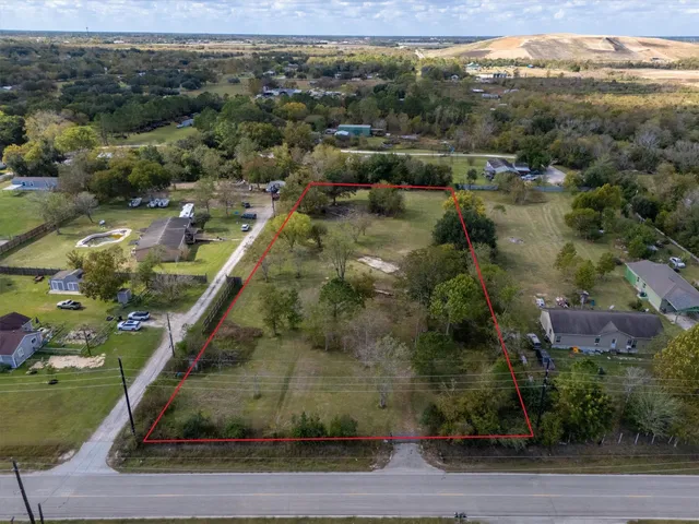 an aerial view of residential houses with outdoor space and street view