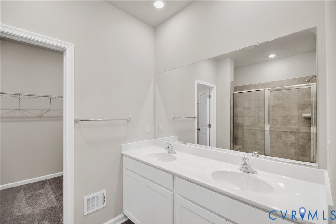 6612 Cassia Loop Moseley, VA 23120 - Photo 14 of 19 a bathroom with a sink and a mirror