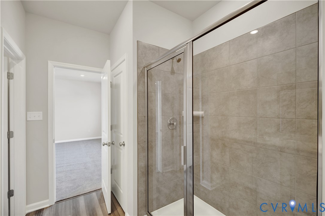 6612 Cassia Loop Moseley, VA 23120 - Photo 15 of 19 a bathroom with a glass door shower