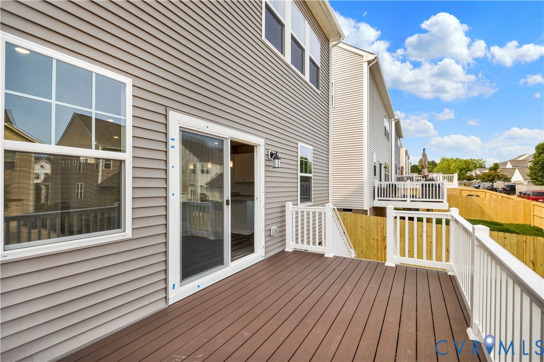 6612 Cassia Loop Moseley, VA 23120 - Photo 18 of 19 a view of a balcony with wooden floor and iron stairs