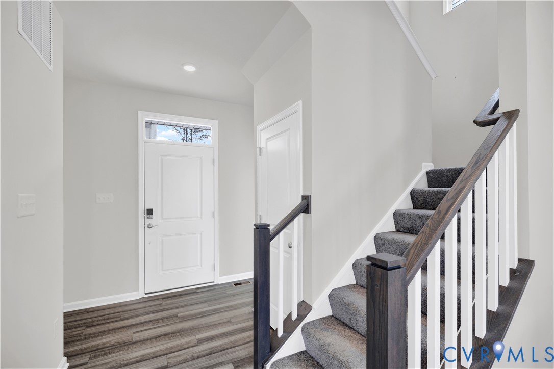 6612 Cassia Loop Moseley, VA 23120 - Photo 2 of 19 a view of entryway with wooden floor and stairs