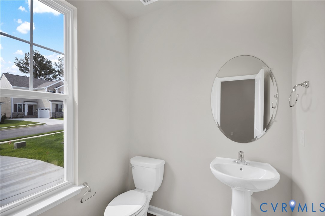 6612 Cassia Loop Moseley, VA 23120 - Photo 7 of 19 a bathroom with a toilet sink and mirror