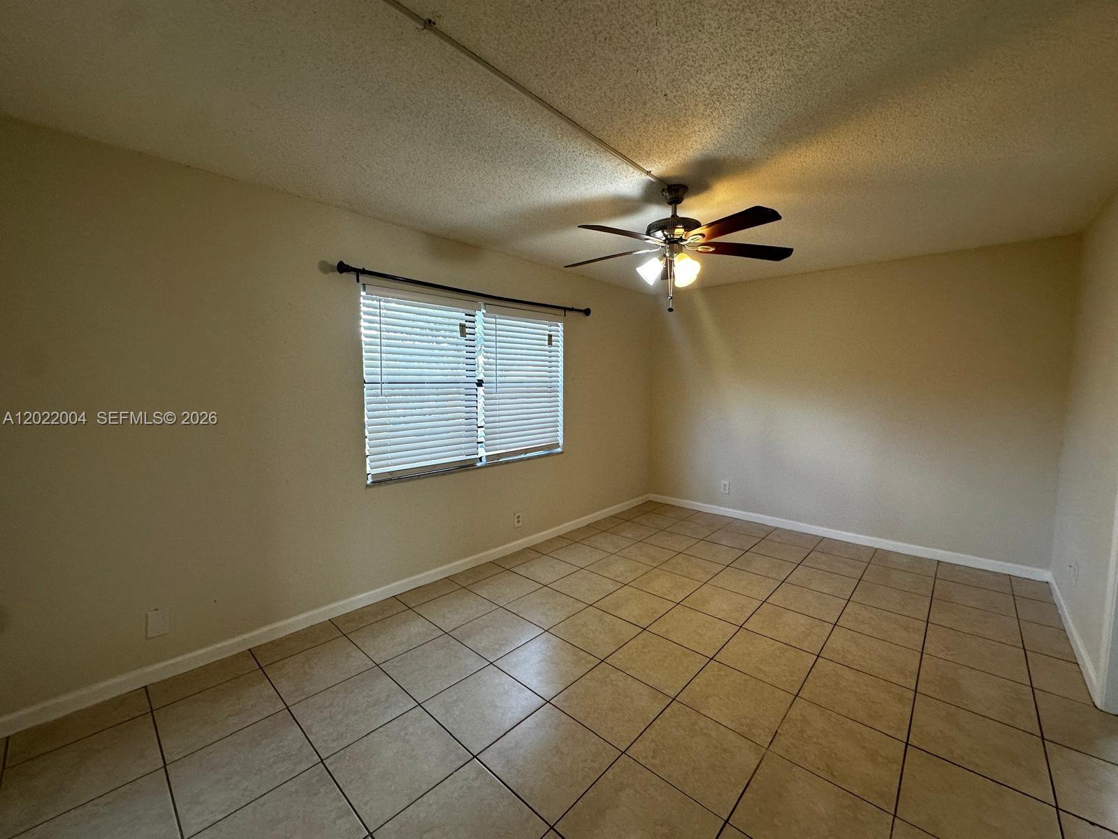 3400 Foxcroft Road, Unit 301 Miramar, FL 33025 - Photo 54 of 72 an empty room with windows and ceiling fan