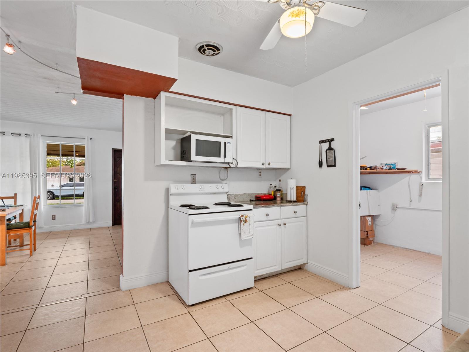 6111 Southwest 20th Court Miramar, FL 33023 - Photo 11 of 31 a kitchen with stainless steel appliances granite countertop a refrigerator and a stove top oven