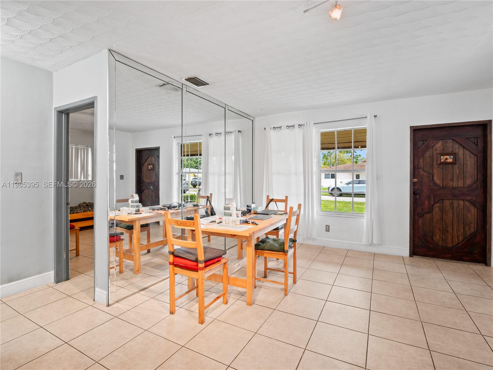 6111 Southwest 20th Court Miramar, FL 33023 - Photo 14 of 31 a view of a dining room with furniture and a window