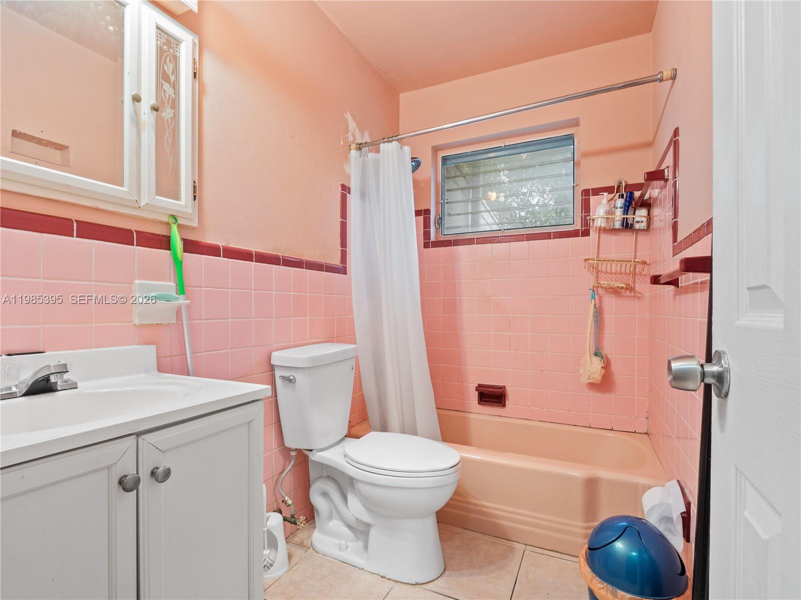 6111 Southwest 20th Court Miramar, FL 33023 - Photo 19 of 31 a bathroom with a sink a toilet and shower