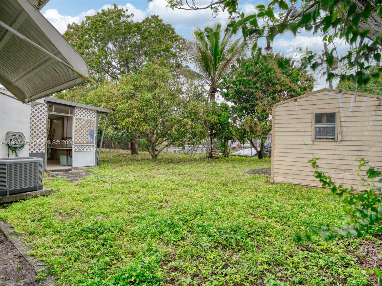 6111 Southwest 20th Court Miramar, FL 33023 - Photo 27 of 31 a backyard of a house with plants and large tree