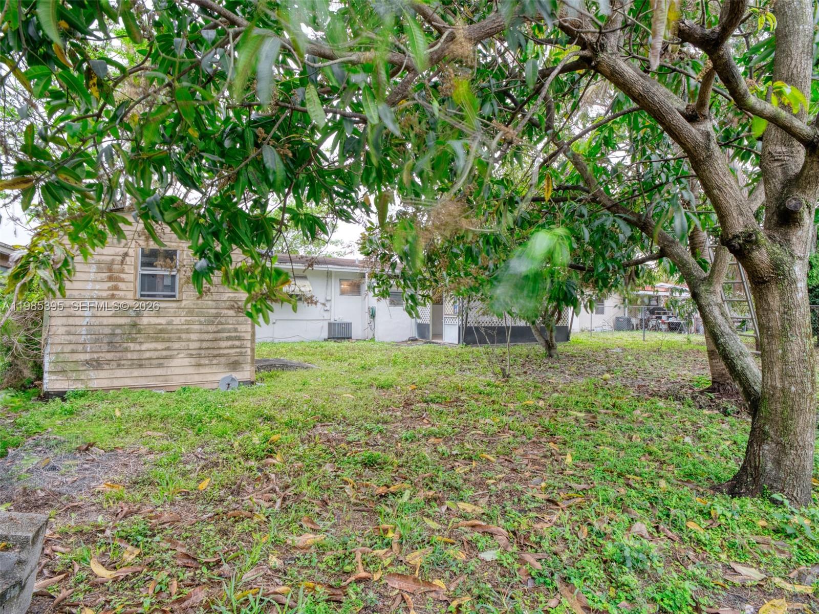 6111 Southwest 20th Court Miramar, FL 33023 - Photo 28 of 31 a view of a backyard with large trees