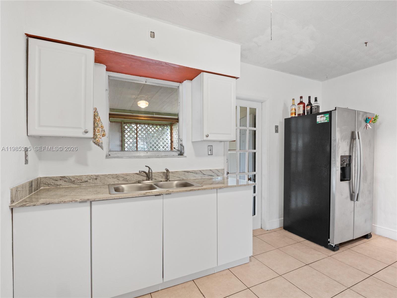 6111 Southwest 20th Court Miramar, FL 33023 - Photo 10 of 31 a kitchen with stainless steel appliances granite countertop a refrigerator and a sink