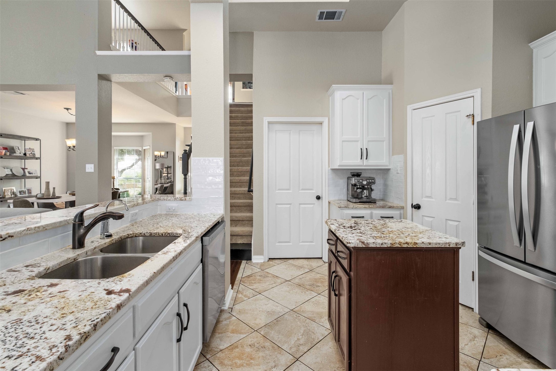 3704 Runnels Court Austin, TX 78732 - Photo 10 of 30 Kitchen featuring a sink, a high ceiling, and stainless steel appliances