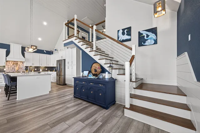 a living room with wooden floor and furniture