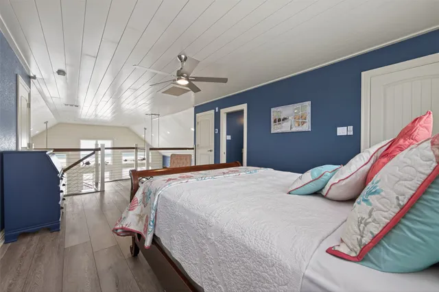 a bedroom with a large bed and a chandelier