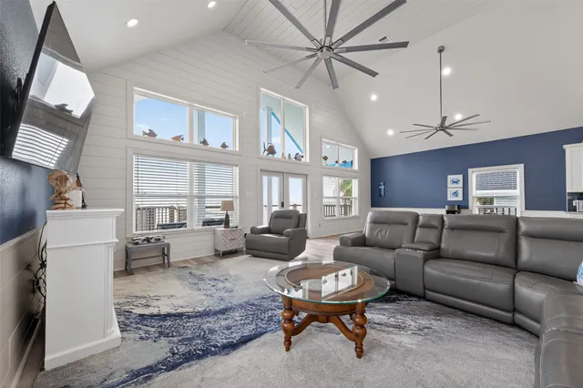 a living room with furniture and a chandelier