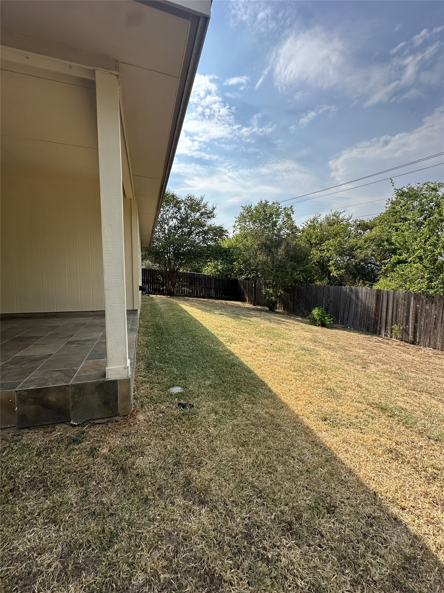 722 Ranier Lane Round Rock, TX 78665 - Photo 20 of 24 An expansive backyard lawn is fully enclosed by a classic wood privacy fence.