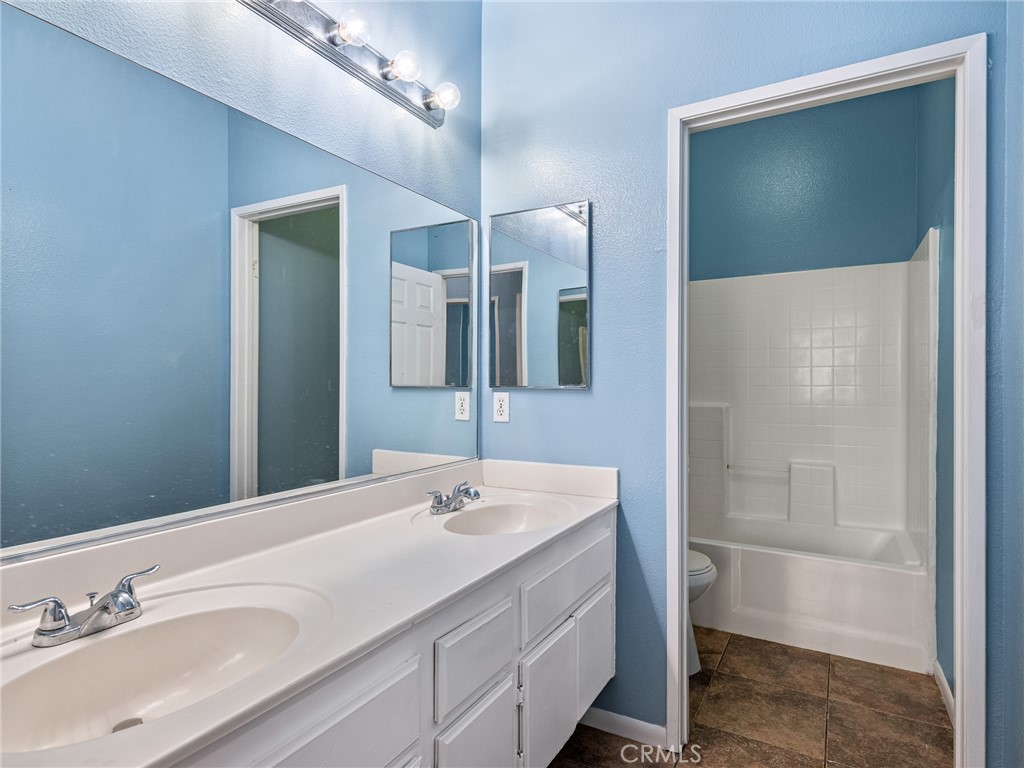 14400 Jeremiah Street Adelanto, CA 92301 - Photo 14 of 45 a bathroom with a sink and a mirror