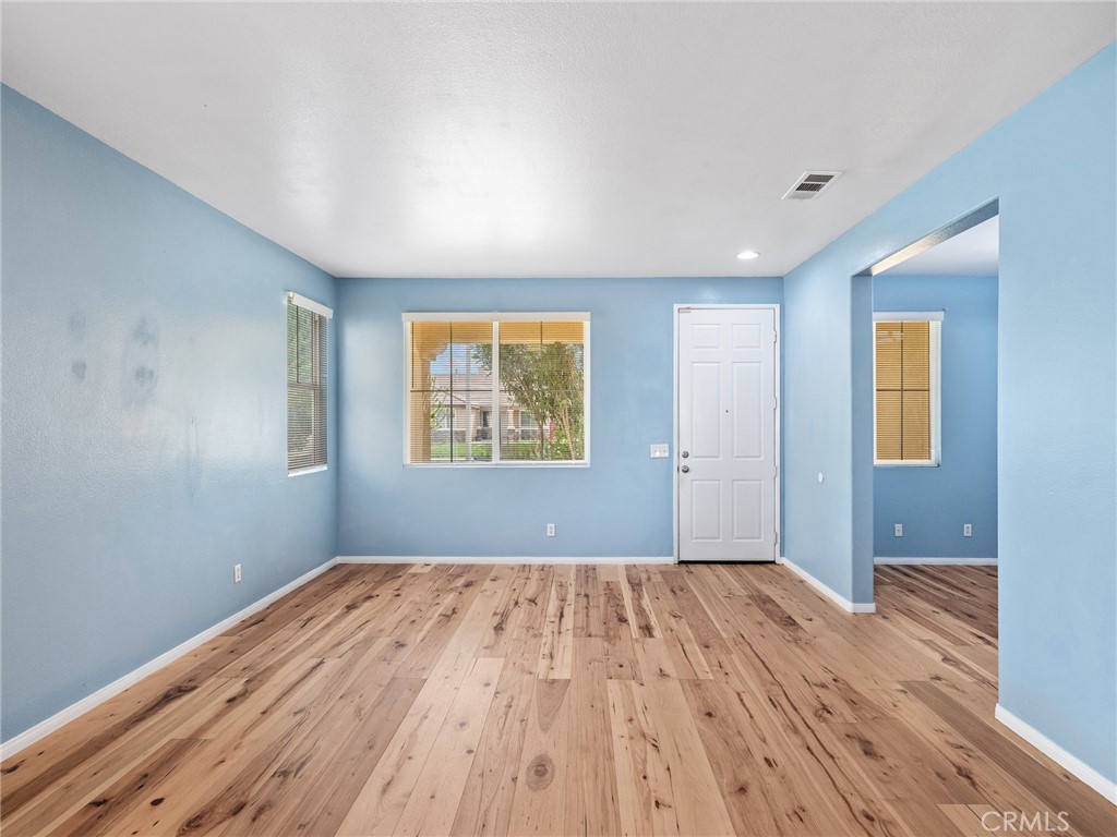 14400 Jeremiah Street Adelanto, CA 92301 - Photo 2 of 45 a view of a room with wooden floor and window