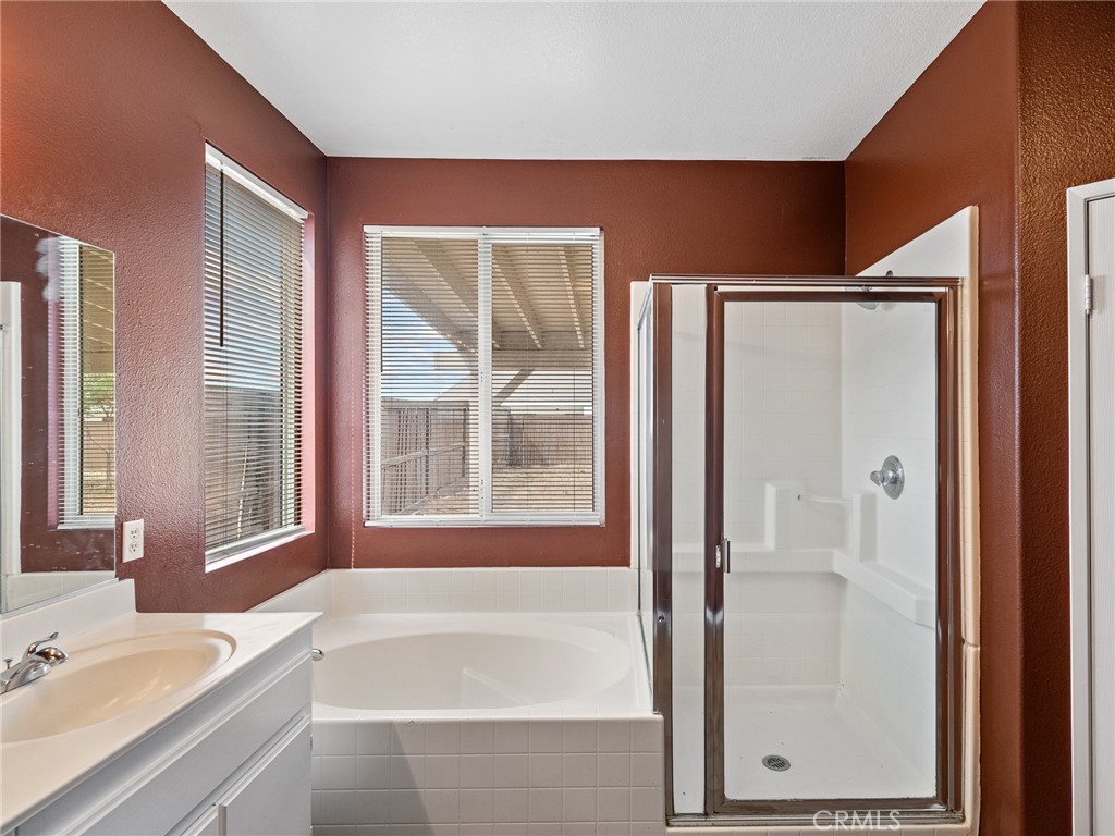 14400 Jeremiah Street Adelanto, CA 92301 - Photo 30 of 45 a bathroom with a bathtub and a sink