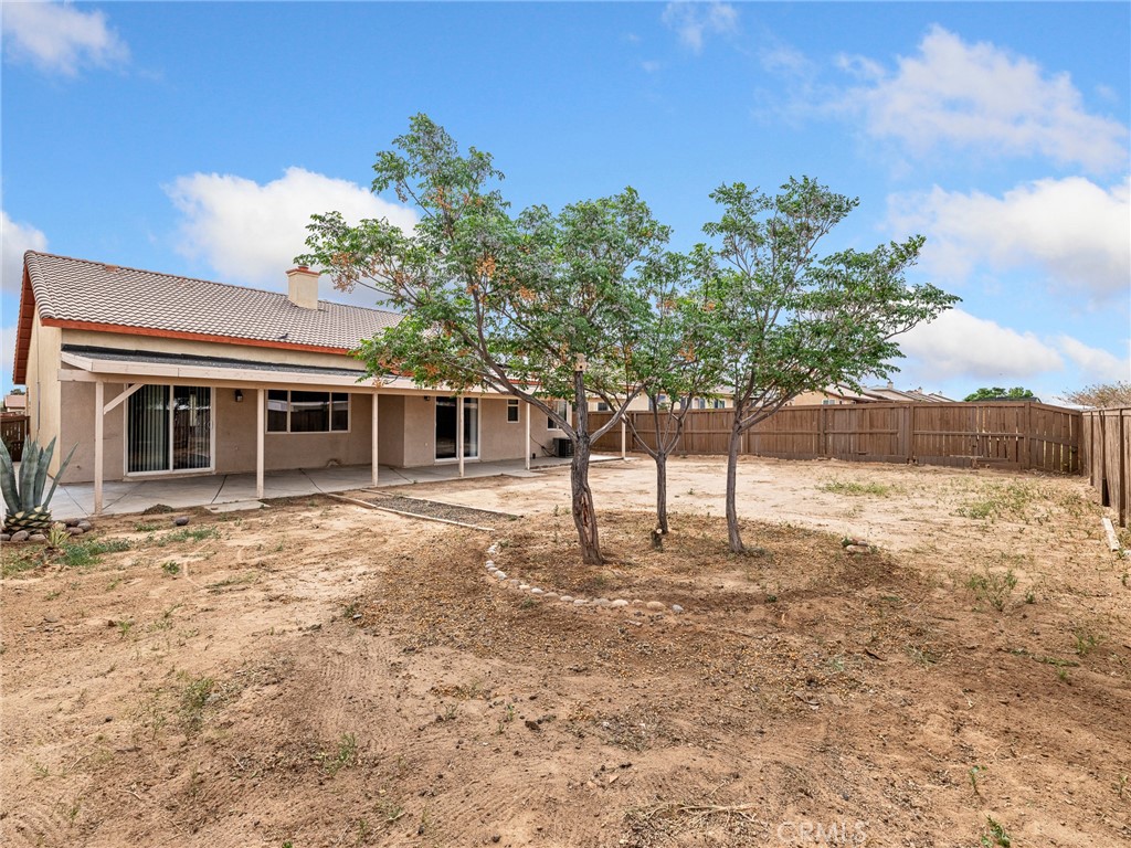 14400 Jeremiah Street Adelanto, CA 92301 - Photo 36 of 45 a front view of a house with a yard
