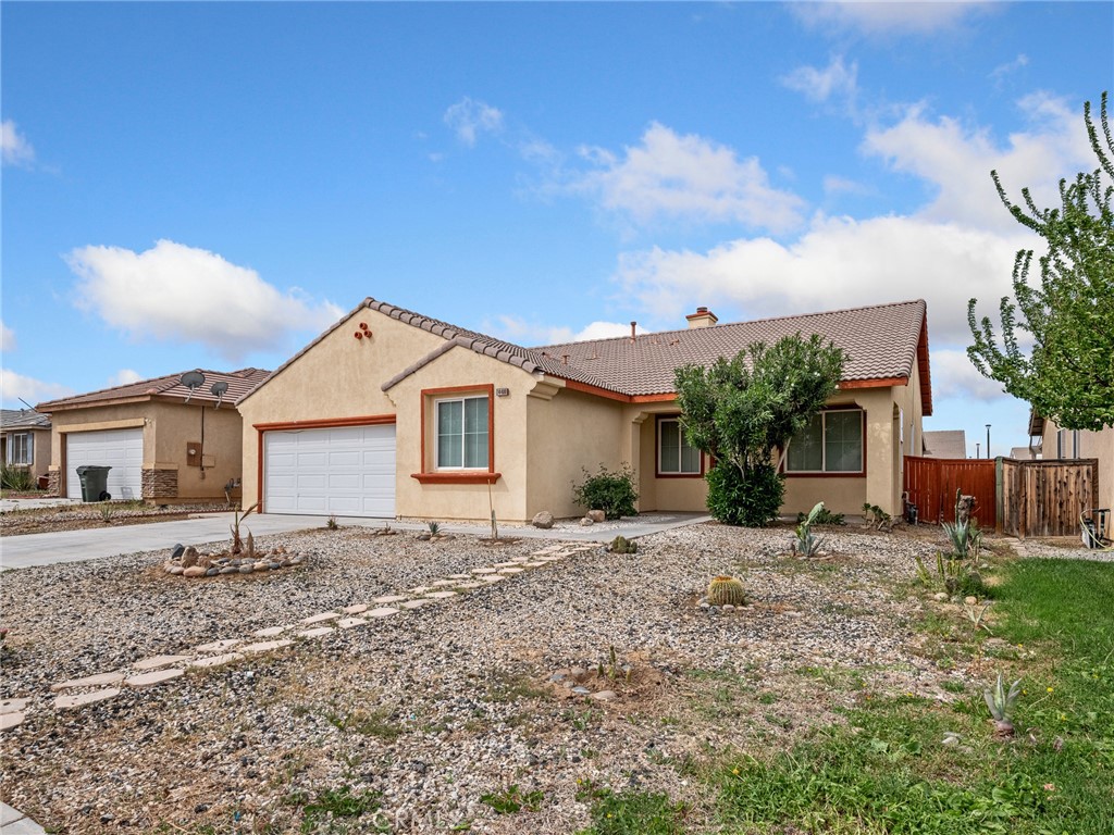 14400 Jeremiah Street Adelanto, CA 92301 - Photo 38 of 45 a front view of a house with a yard
