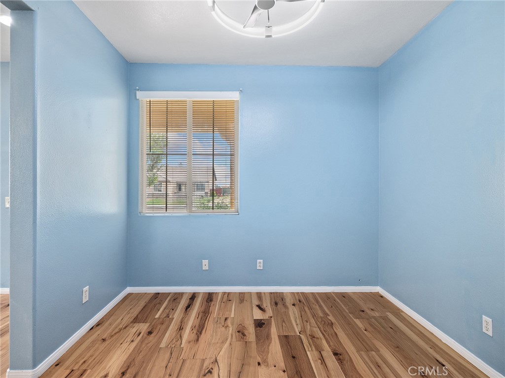 14400 Jeremiah Street Adelanto, CA 92301 - Photo 5 of 45 a view of a room with wooden floor and windows