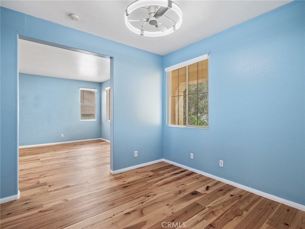 14400 Jeremiah Street Adelanto, CA 92301 - Photo 6 of 45 a view of empty room with wooden floor and fan