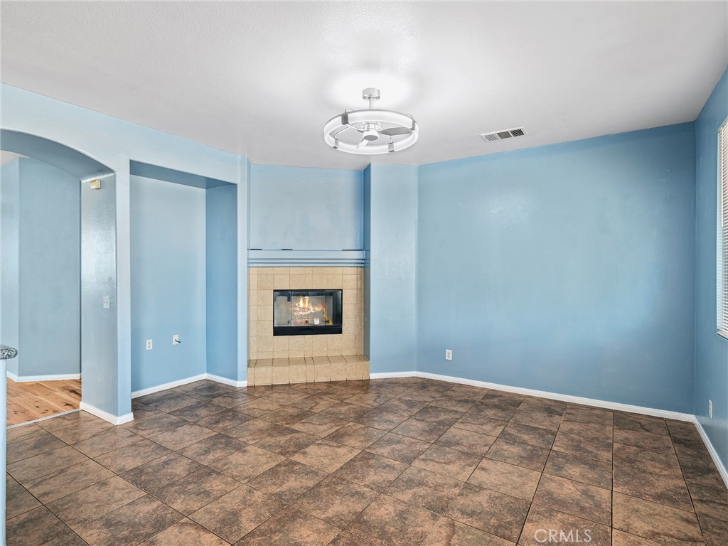 14400 Jeremiah Street Adelanto, CA 92301 - Photo 7 of 45 a view of an empty room with a chandelier fan