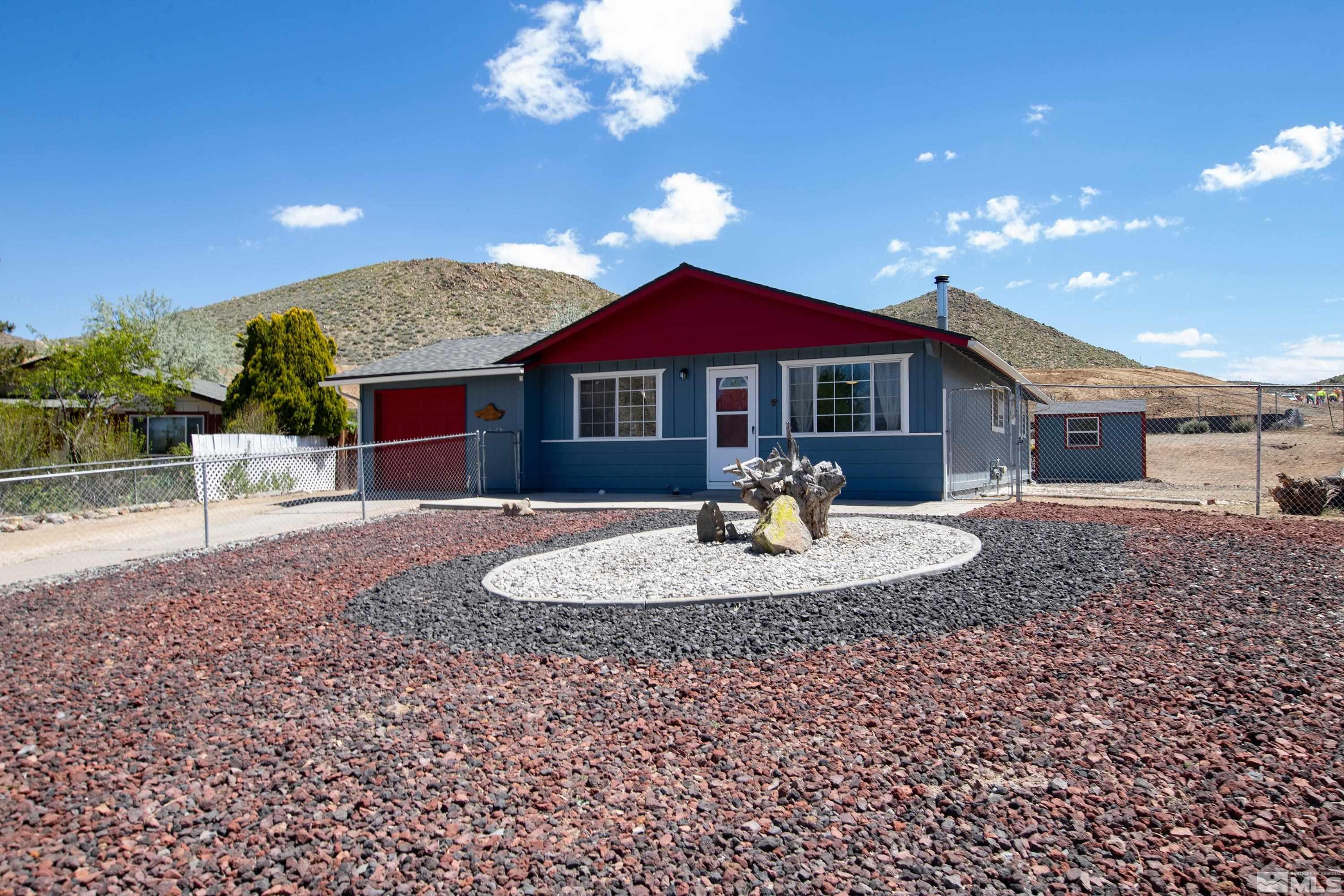 635 Wiggins Court Reno, NV 89506 - Photo 1 of 20 a front view of a house with a yard patio and fire pit
