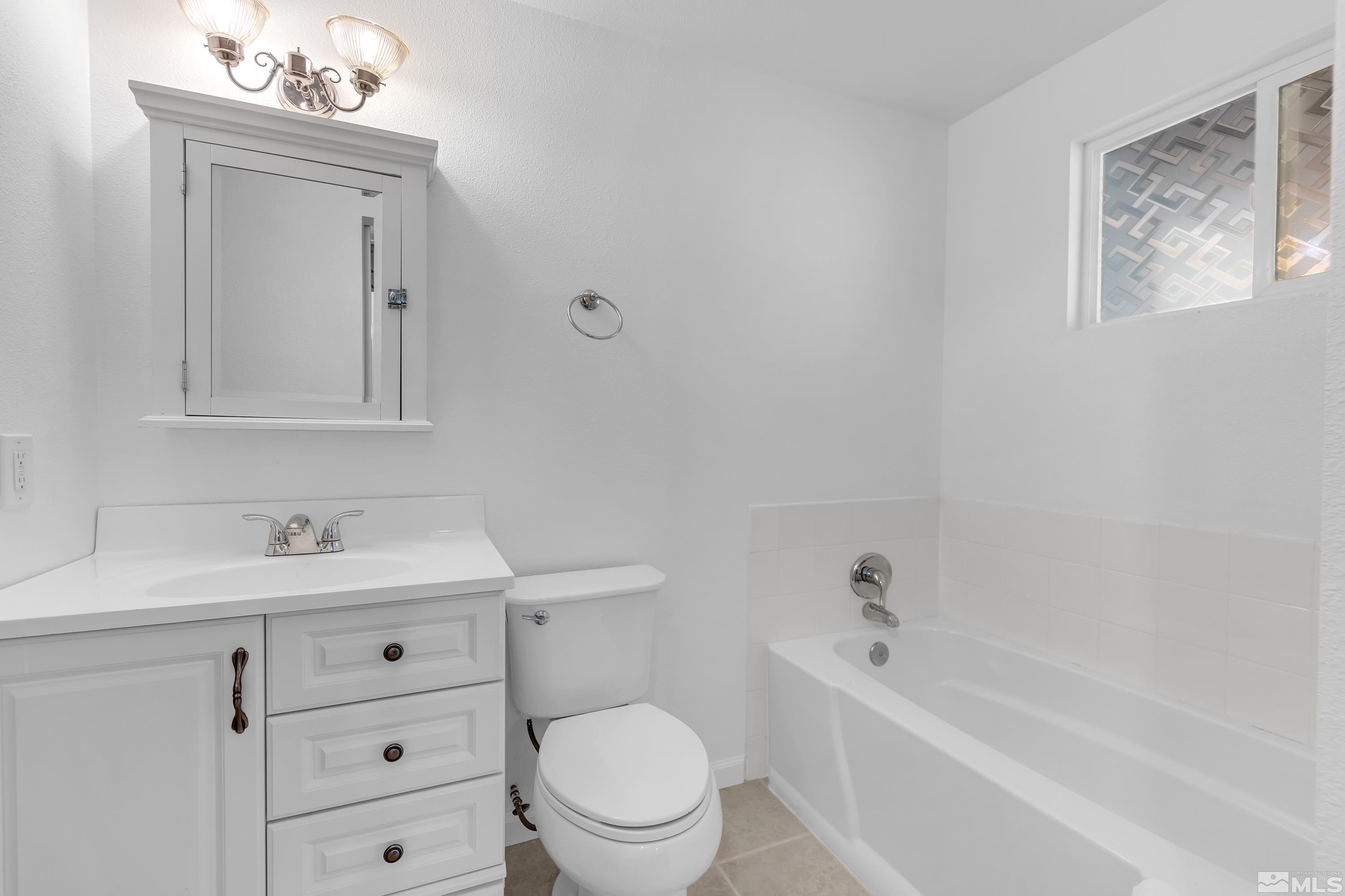 635 Wiggins Court Reno, NV 89506 - Photo 14 of 20 a bathroom with a sink a toilet and shower