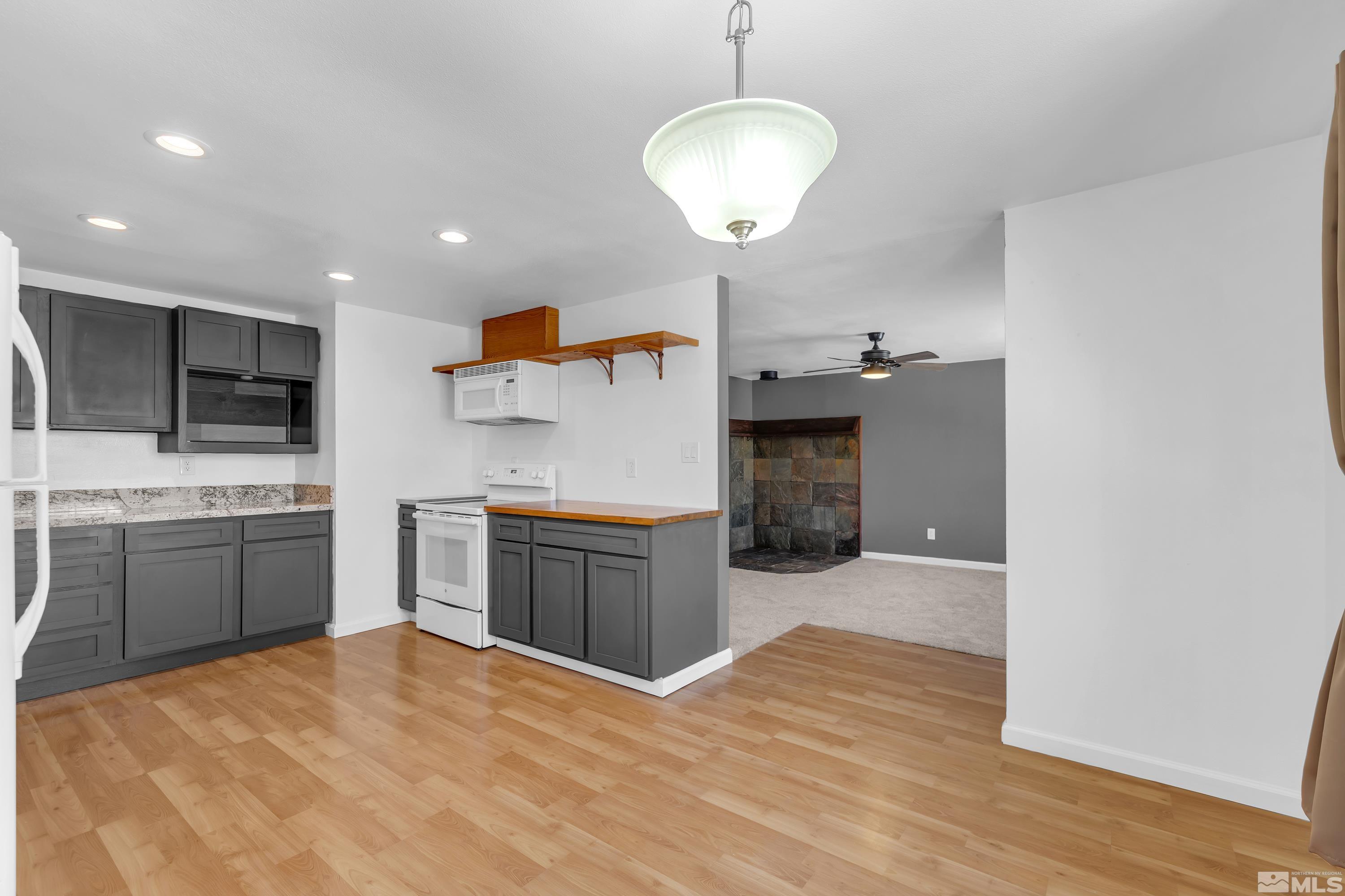 635 Wiggins Court Reno, NV 89506 - Photo 4 of 20 a large kitchen with stainless steel appliances kitchen island granite countertop a sink and cabinets
