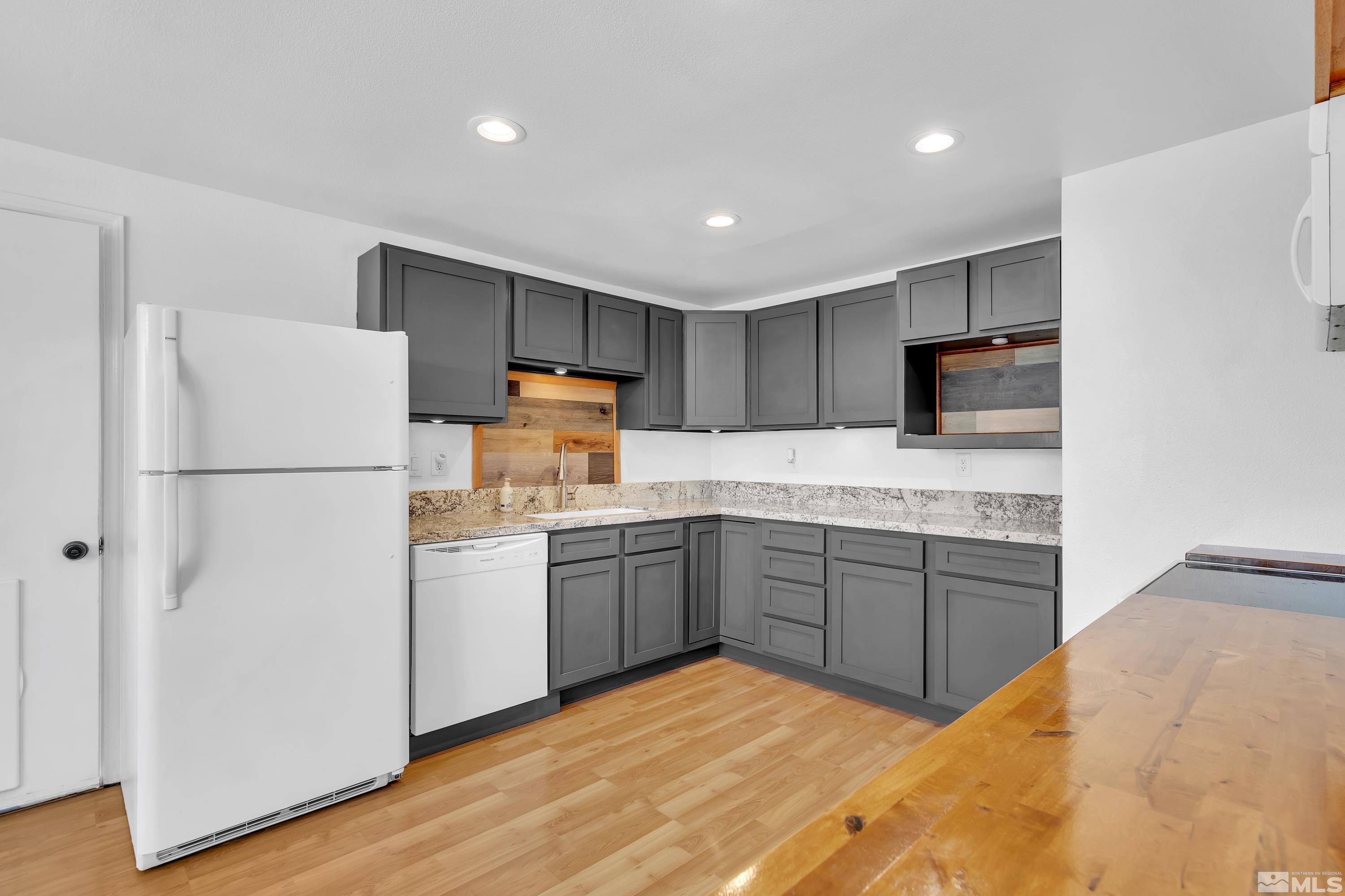 635 Wiggins Court Reno, NV 89506 - Photo 5 of 20 a kitchen with granite countertop appliances a sink and a refrigerator