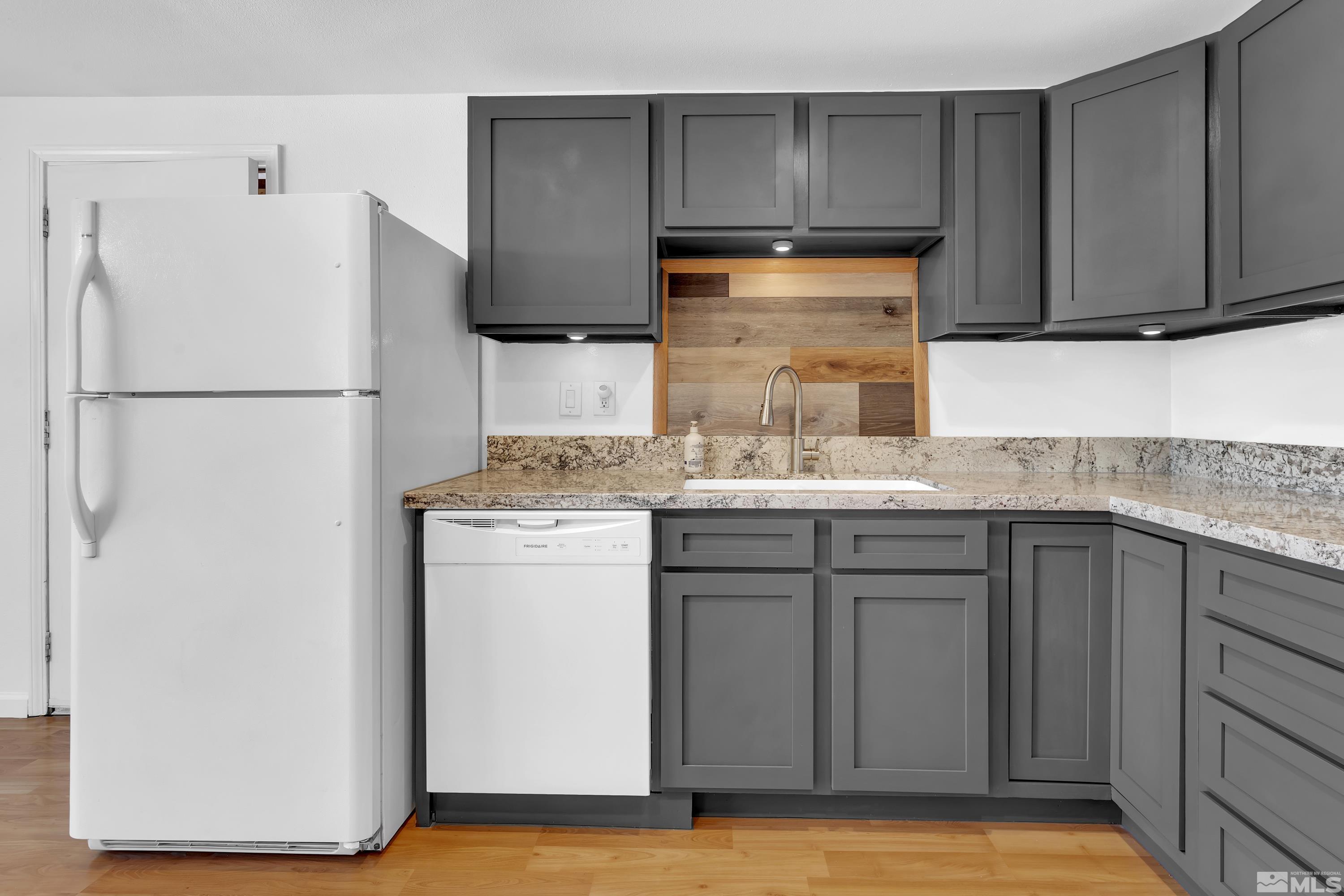 635 Wiggins Court Reno, NV 89506 - Photo 6 of 20 a kitchen with a sink cabinets and a refrigerator