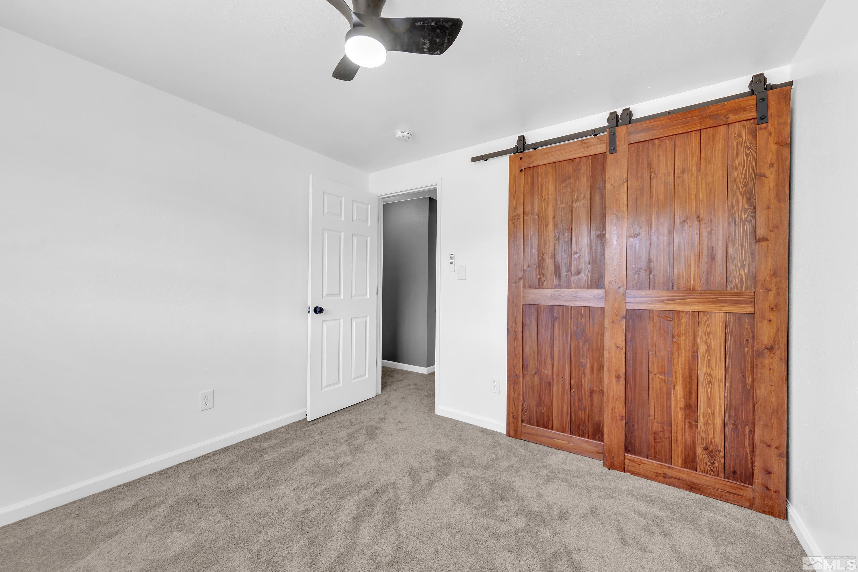 635 Wiggins Court Reno, NV 89506 - Photo 7 of 20 an empty room with wooden floor and fan