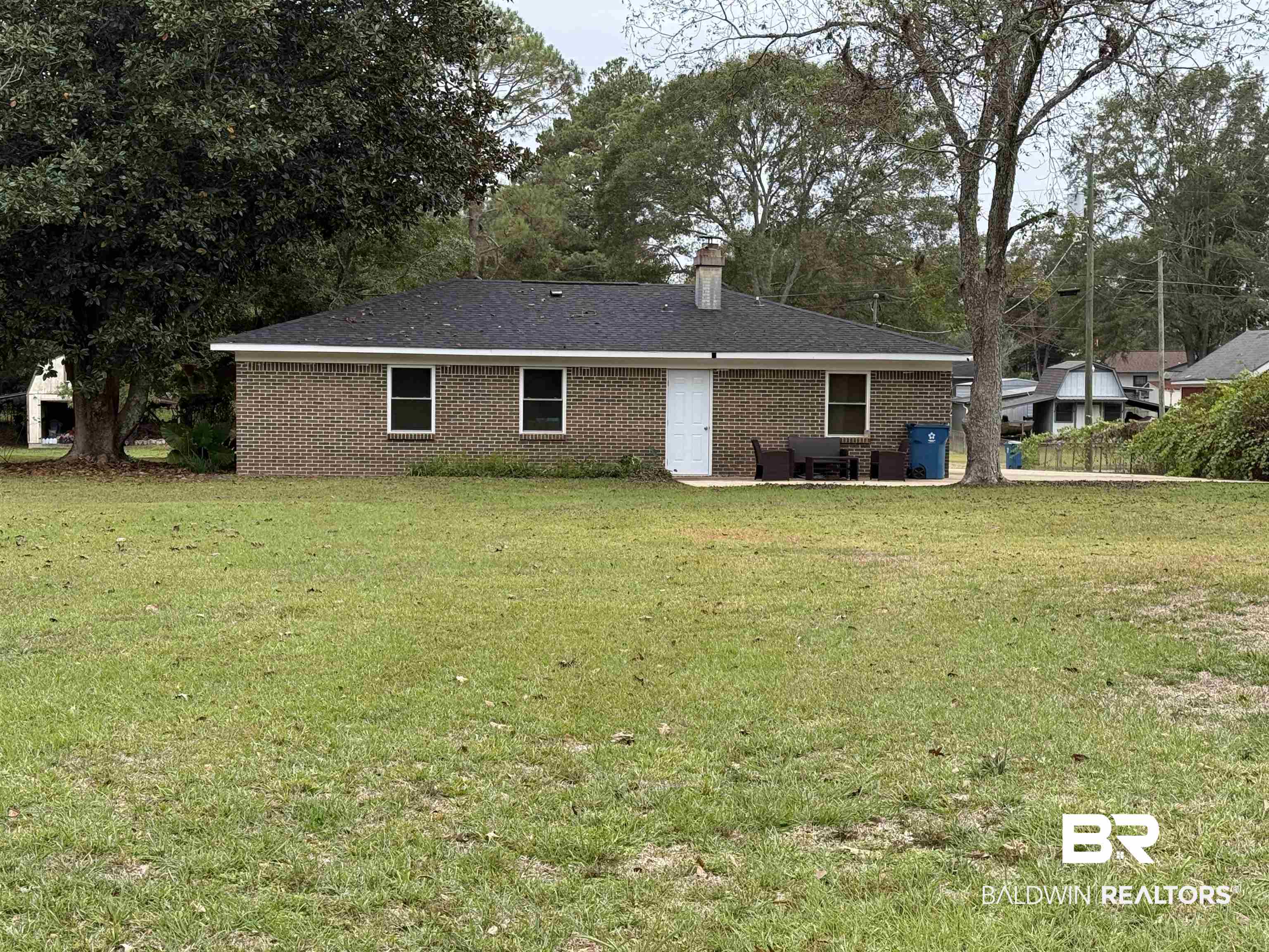 90 Florida Street Monroeville, AL 36460 - Photo 5 of 31 Back of house with a yard