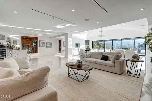 a living room with furniture and a chandelier