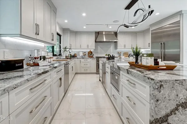 a living room with furniture a flat screen tv and a window