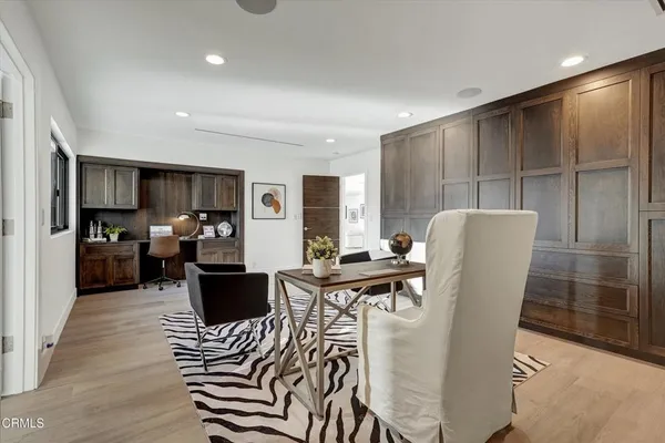 a bedroom with a bed a table and painting on the wall