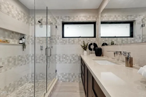 a bedroom with a bed and painting on the wall