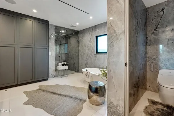 a bedroom with furniture and a wooden floor