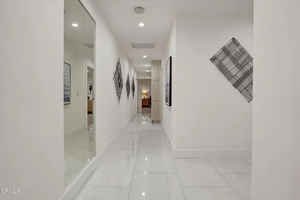 a bathroom with a sink a toilet a mirror and bathtub