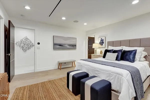 a bedroom with a large bed and a large window